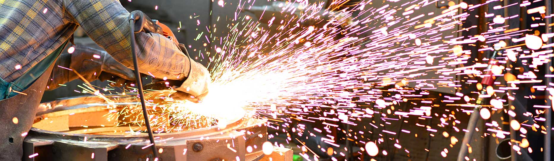 Workers sanding a casting in an industrial company