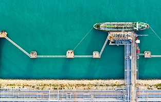 Tanker ship transporting oil from refinery unloading at port